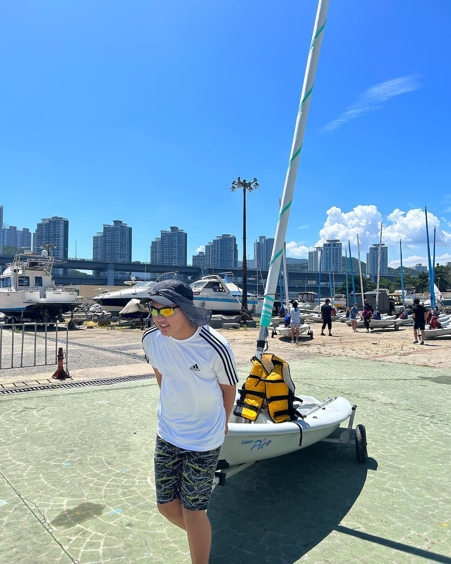Ashton Jung with a sailboat at a marina